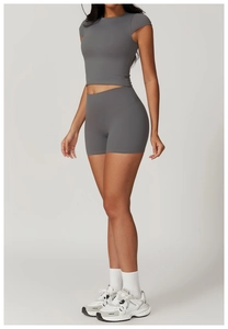 Deep grey two-piece yoga set showing slim fit crop top and high-waisted shorts on a model