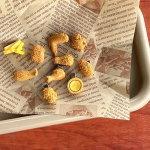 Creative realistic food hair clips featuring fried chicken wings and fries on vintage paper