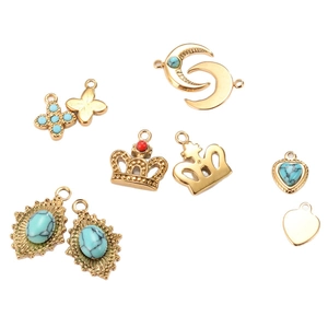 French court style gold titanium steel pendants with turquoise and red stones on white background