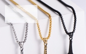 Detailed macro view of Eiffel Tower pendants in silver, gold and black vintage finishes