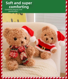 Close-up of Christmas teddy bears in Santa outfits on a soft cream sofa setup