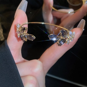 Detail of gold leaf bangle with sparkling purple and clear zircon flower clusters