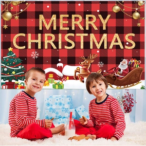 Red and black plaid Christmas backdrop with golden Merry Christmas text and cozy holiday setup
