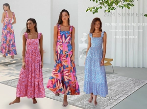 Detail of bohemian summer maxi dresses with multi-layered ruffles and floral patterns