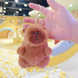 Detailed plush texture of a brown capybara keychain with a gold metal spring hook