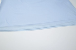 Detail view of the light blue dress hem with professional double-needle stitching quality