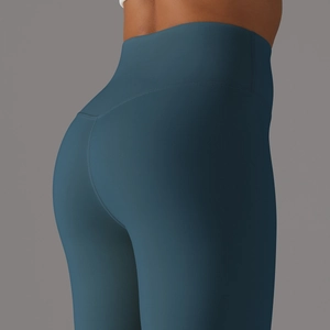 Detailed back view of high-waist teal yoga leggings showing seamless butt-lifting design