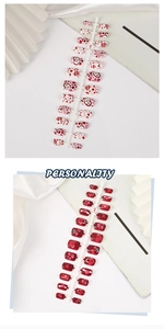 Detail view of square press-on nails featuring red heart and cherry patterns on plastic trays