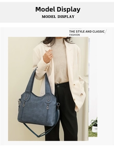 Blue tote bag showing fine faux leather texture and decorative zippers on model