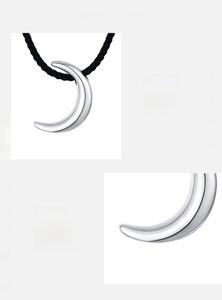 Macro shot of polished S925 sterling silver moon pendant with black cord necklace details
