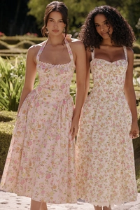 Close-up of pink floral print fabric with delicate lace trim on the summer dress hem