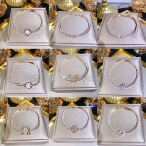 Gold plated zircon charm bracelets with clover, butterfly, and horseshoe designs
