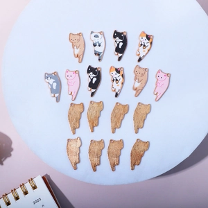 Macro detail of various colorful cat enamel charms with gold alloy base for DIY jewelry