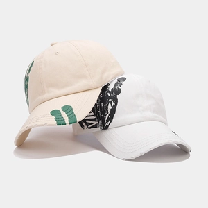 Unisex cotton baseball cap with graffiti prints and distressed brim in ivory white
