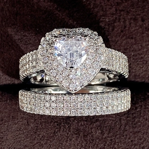 Macro view of silver heart-shaped zircon bridal ring set with detailed sparkling stones