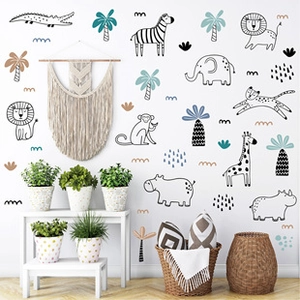 Nursery wall stickers featuring hand-drawn jungle animals in a cozy room setting