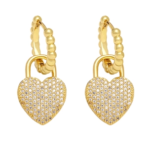 Detailed macro shot of gold heart-shaped lock earrings with pavé set cubic zirconia