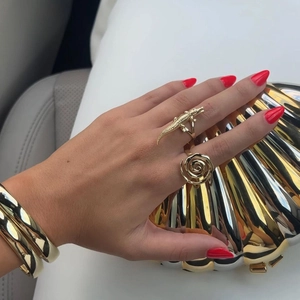 Polished 18k gold-plated jewelry set featuring crocodile ring and wide cuff bracelet
