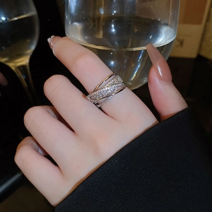Elegant silver multi-layer crisscross ring with sparkling zircons worn on a hand