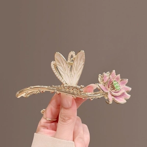 Detail of golden dragonfly lotus hair claw clip with pearls and pink enamel