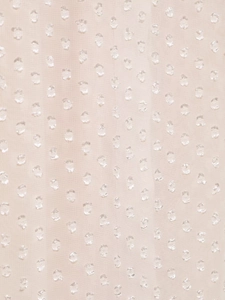 Detailed macro view of beige chiffon fabric featuring elegant white textured polka dots