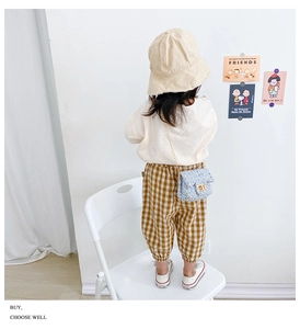 Toddler girl wearing beige bucket hat and blue tweed chain crossbody bag set