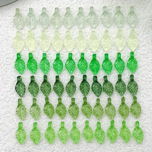 Detailed view of colorful transparent acrylic leaf charms for DIY jewelry making