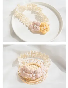 Detail of baby lace headbands with handmade fabric flowers and imitation pearls