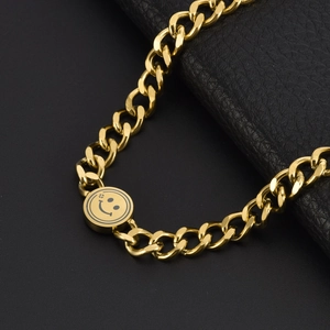 Elegant gold titanium steel Cuban chain bracelet with a polished smiley face pendant