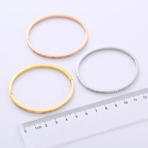 Three-piece minimalist stainless steel bangles set in gold, silver, and rose gold with cz stones