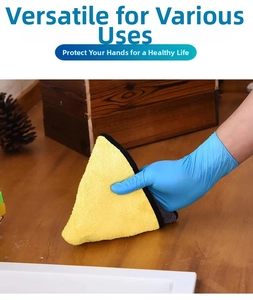 Blue disposable nitrile glove used with yellow microfiber cloth on wooden surface
