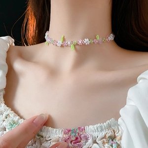 Close-up of handmade colorful flower beaded necklace worn on neck for a sweet summer look
