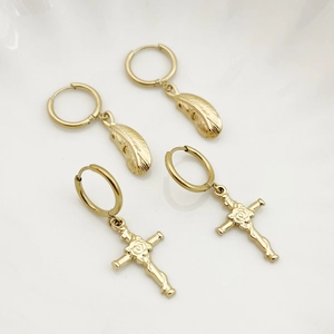 Golden titanium steel hoop earrings featuring feather and rose cross pendants on white background