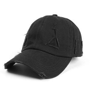 Distressed black cotton baseball cap with ripped details and curved brim for outdoor wear