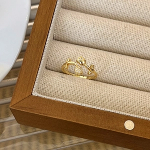 Close-up of gold tulip ring with sparkling micro-pave diamonds in a premium jewelry box