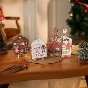 Detail of wooden gingerbread man tabletop signs with festive Christmas decorations