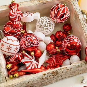 Red and white Christmas ball set with assorted ornaments in a vintage wooden box