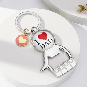 Detail of silver bottle opener keychain with I Love Dad glass cabochon and pink heart charm