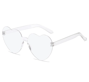 Detail view of transparent heart-shaped rimless sunglasses with integrated lens design