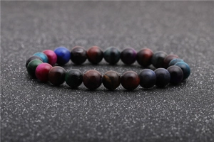 Macro shot of colorful tiger eye stone beads on an elastic bracelet with smooth texture