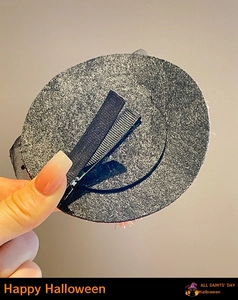 Detail view showing the secure metal alligator clip and grey felt base on the Halloween hair clip