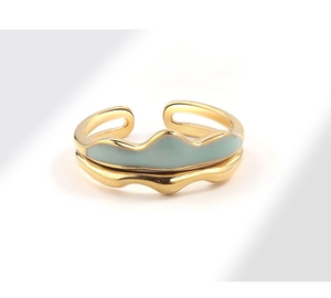 Detail showing wavy gold-plated adjustable ring with light blue enamel dripping finish