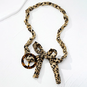 Fashionable leopard print belt with gold chain weave and round tortoiseshell buckle