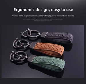 Close-up of woven suede car keychains in dark grey, brown and green with gunmetal hardware