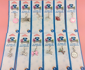 Set of 12 sparkling rhinestone pet collar charms with bone and heart shapes on display