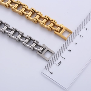 Detailed comparison of gold and silver stainless steel bike chain bracelets with scale