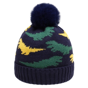 Navy blue baby knitted hat with yellow and green dinosaur patterns and a soft pom-pom