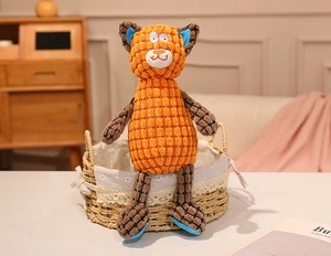 Detail of orange corduroy plush toy with checkered limb accents and blue foot pads