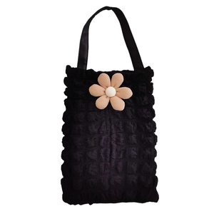 Detail of black bubble texture car headrest tissue box holder with yellow flower