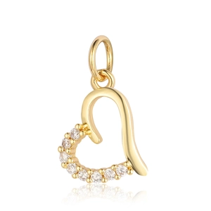 Golden heart pendant with zirconia accents and top link on white reflective surface